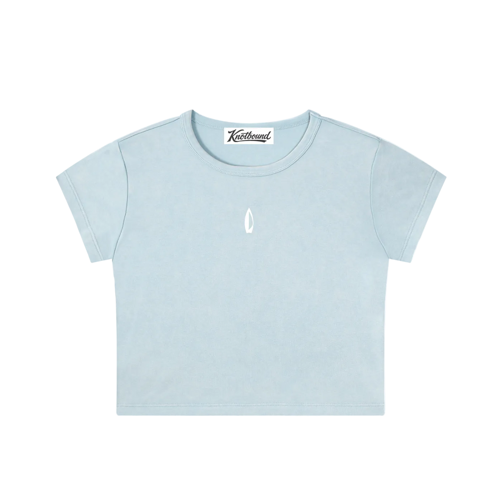 A light blue short-sleeve crop top t-shirt with a small white teardrop logo on the center chest, displayed flat against a solid white background.
