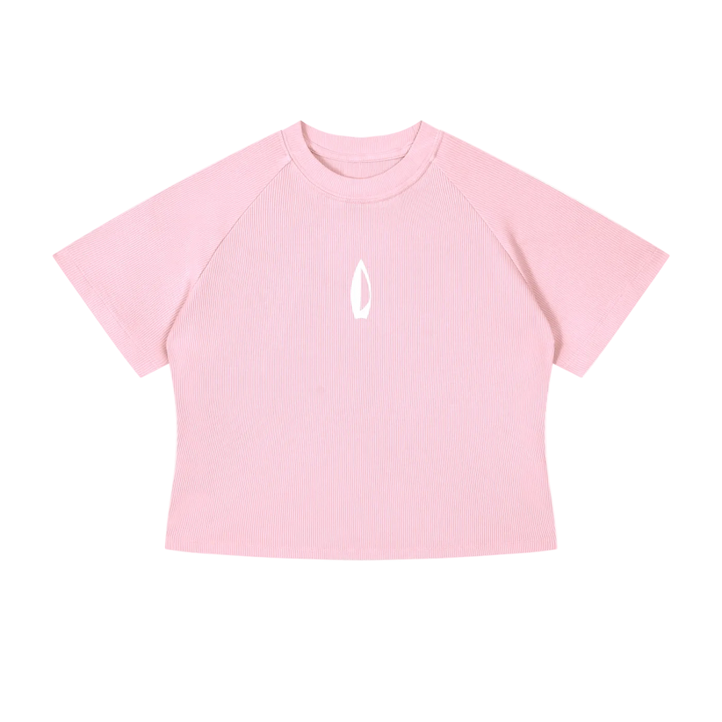 A light pink short-sleeve crop top with raglan sleeves and a small white flame-like logo on the center chest, displayed flat against a solid white background.