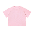 A light pink short-sleeve crop top with raglan sleeves and a small white flame-like logo on the center chest, displayed flat against a solid white background.