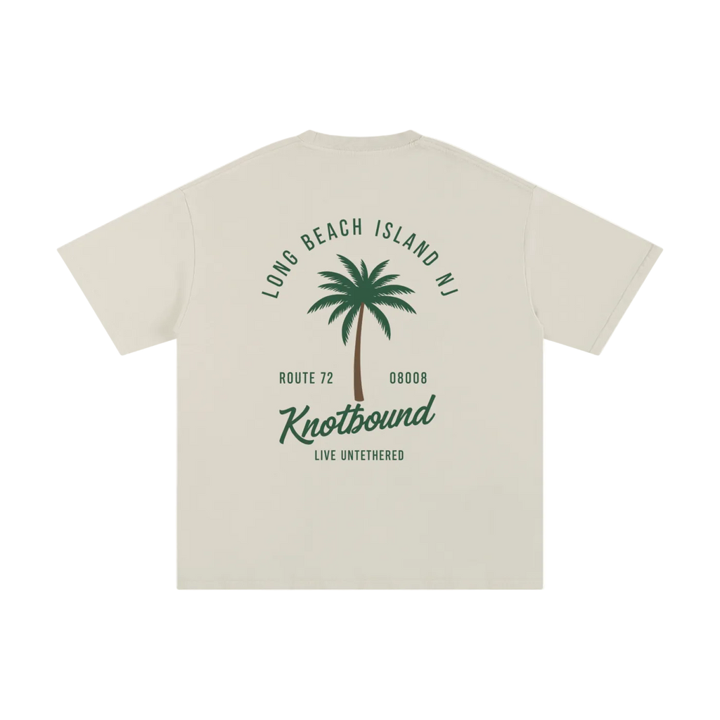 Beige t-shirt with palm tree design and text on a white background