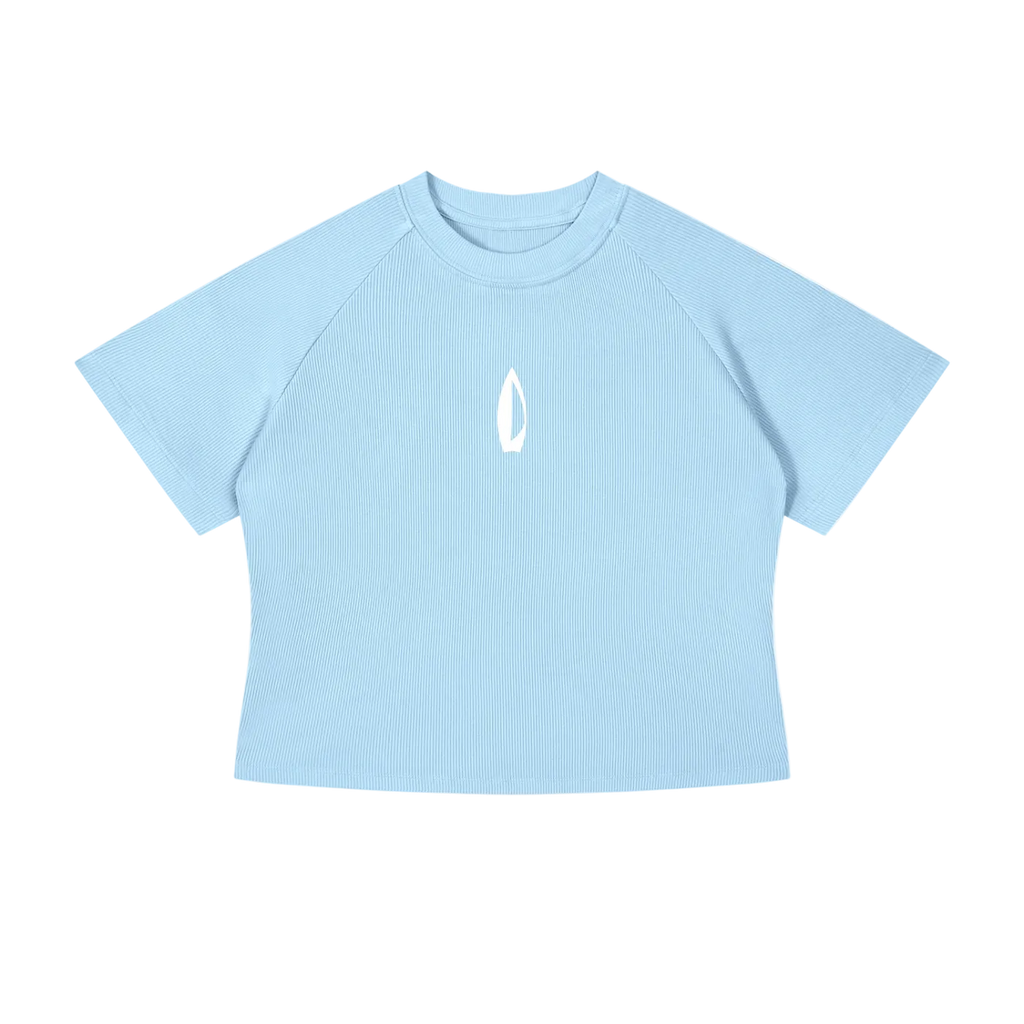 A light blue short-sleeve crop top t-shirt with raglan sleeves and a small white flame logo on the center chest, displayed on a solid white background.