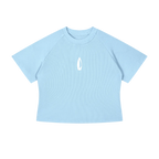 A light blue short-sleeve crop top t-shirt with raglan sleeves and a small white flame logo on the center chest, displayed on a solid white background.