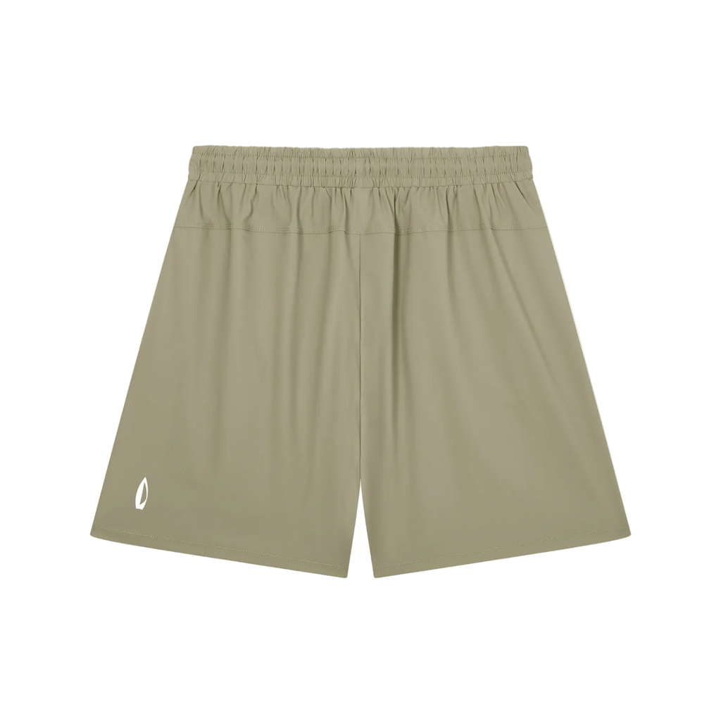 A pair of athletic shorts in a muted khaki or olive-tan color, featuring an elastic waistband and a small white logo on the lower left leg, displayed against a solid white background.