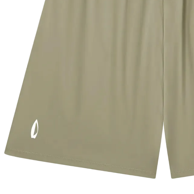 A pair of athletic shorts in a muted sage green color, featuring an elastic waistband and a small white logo on the lower left leg, displayed against a solid white background.