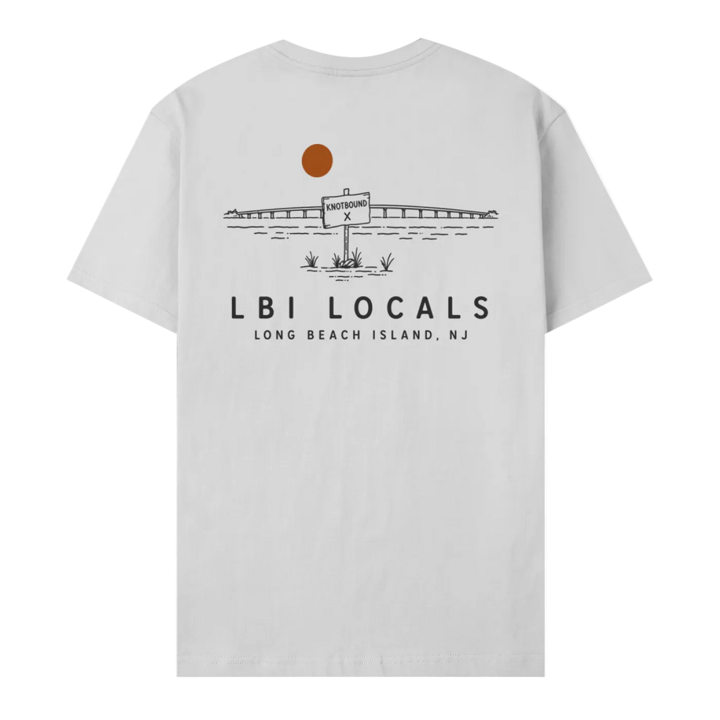 A light gray short-sleeve t-shirt shown from the back, featuring a black line art graphic of a bridge, a sign, and a brown sun, with the text 'LBI LOCALS' and 'LONG BEACH ISLAND, NJ' printed below.