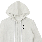A light heather gray zip-up hoodie with white drawstrings and a small black logo on the left chest, displayed against a solid white background.