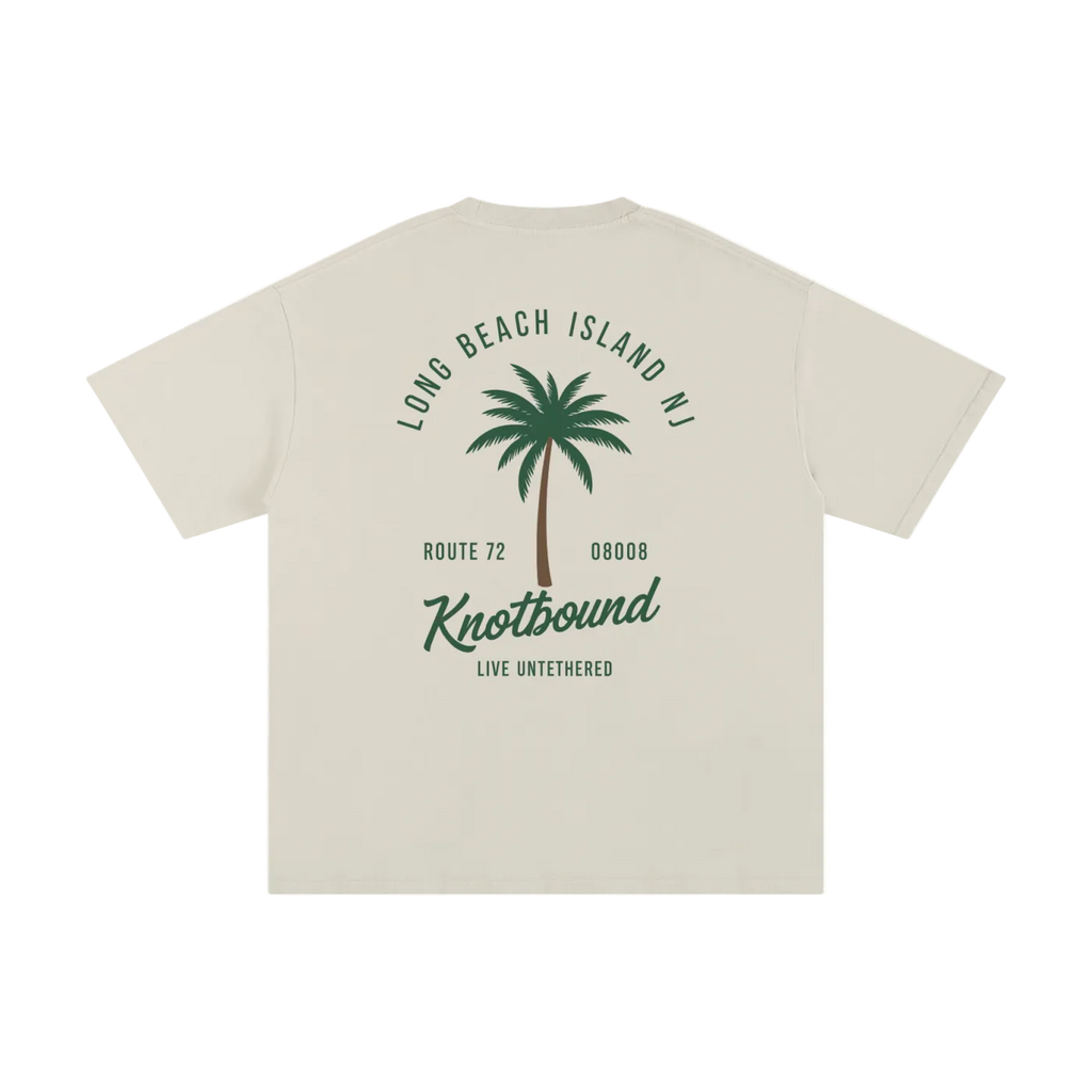 Beige t-shirt with palm tree graphic and text on a white background
