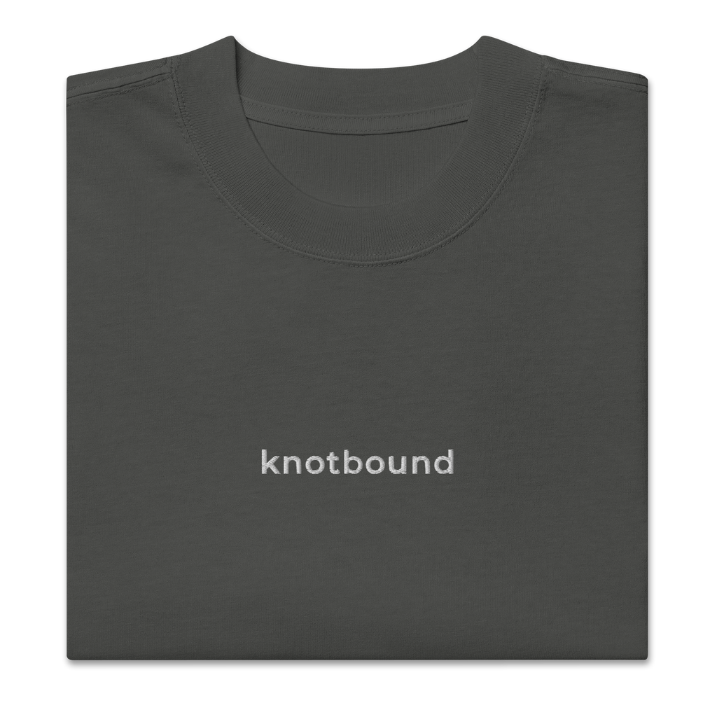 The Knotbound Staple Embroidered Tee in coal, showing the embroidered chest logo.
