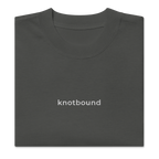 The Knotbound Staple Embroidered Tee in coal, showing the embroidered chest logo.